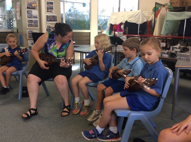 teacher and students playing ukeleles